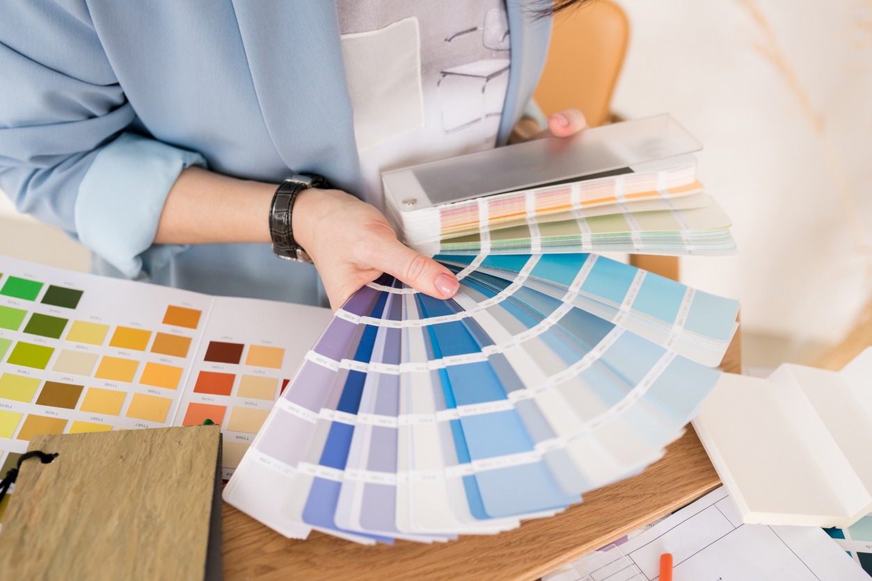 Close-up of architect woman choosing samples of wall paint