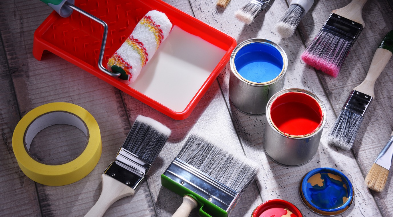 Paintbrushes of different size and paint can