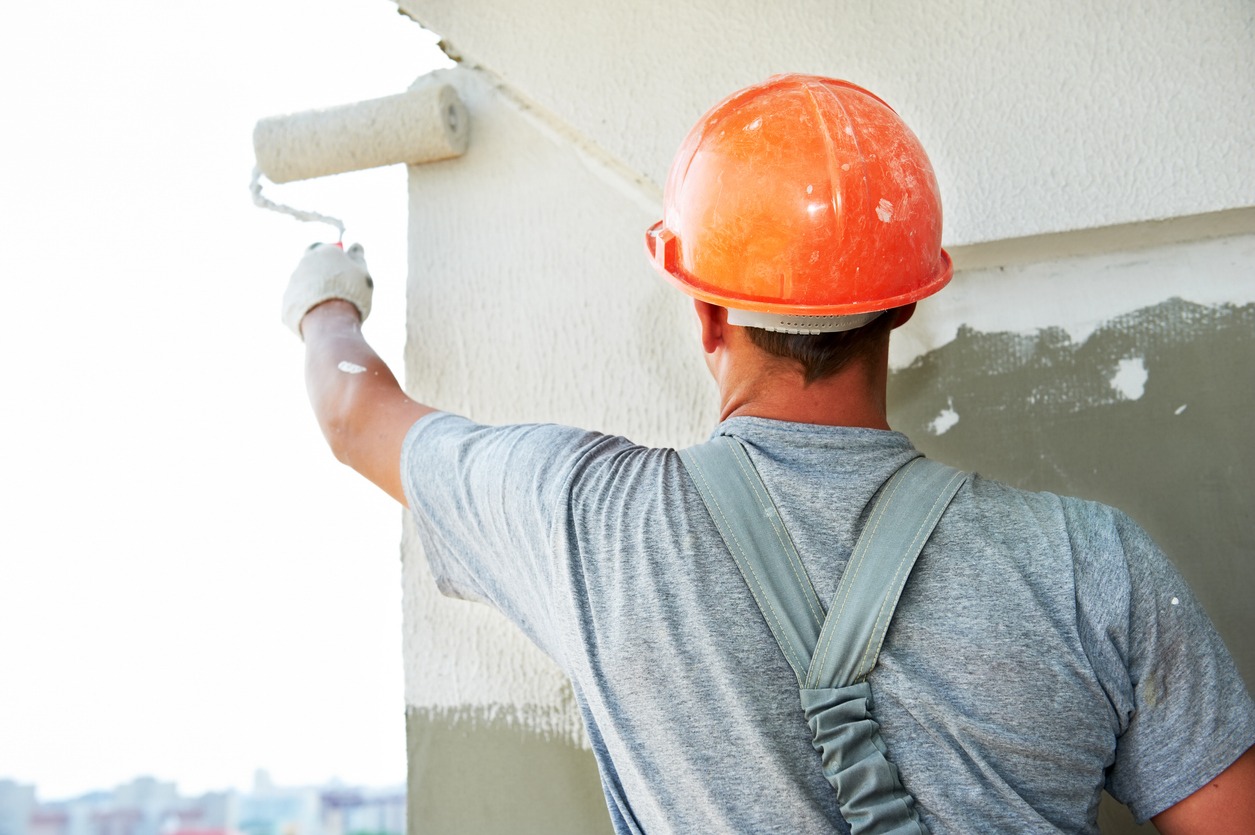 Construction working putting plaster on a wall