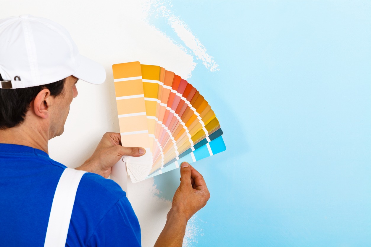 painter man looking a color palette