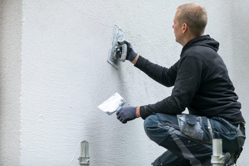 worker putting decorative plaster