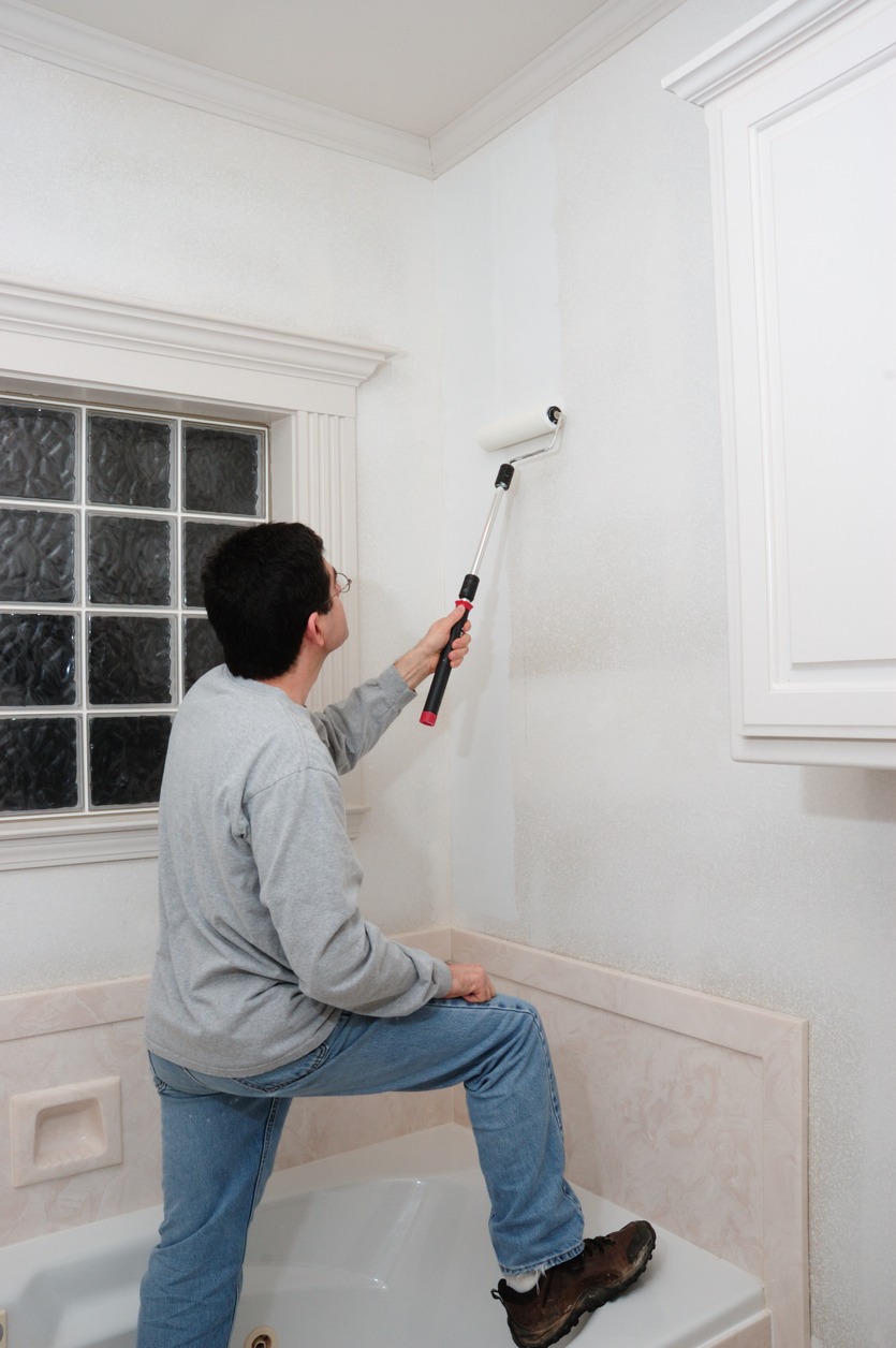 Man Applying Primer to Bathroom Wall