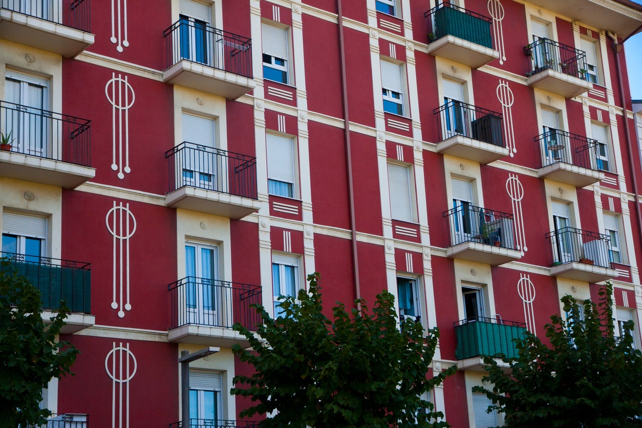 facades of old residential buildings. Windows, balconies, stone, brick, concrete.