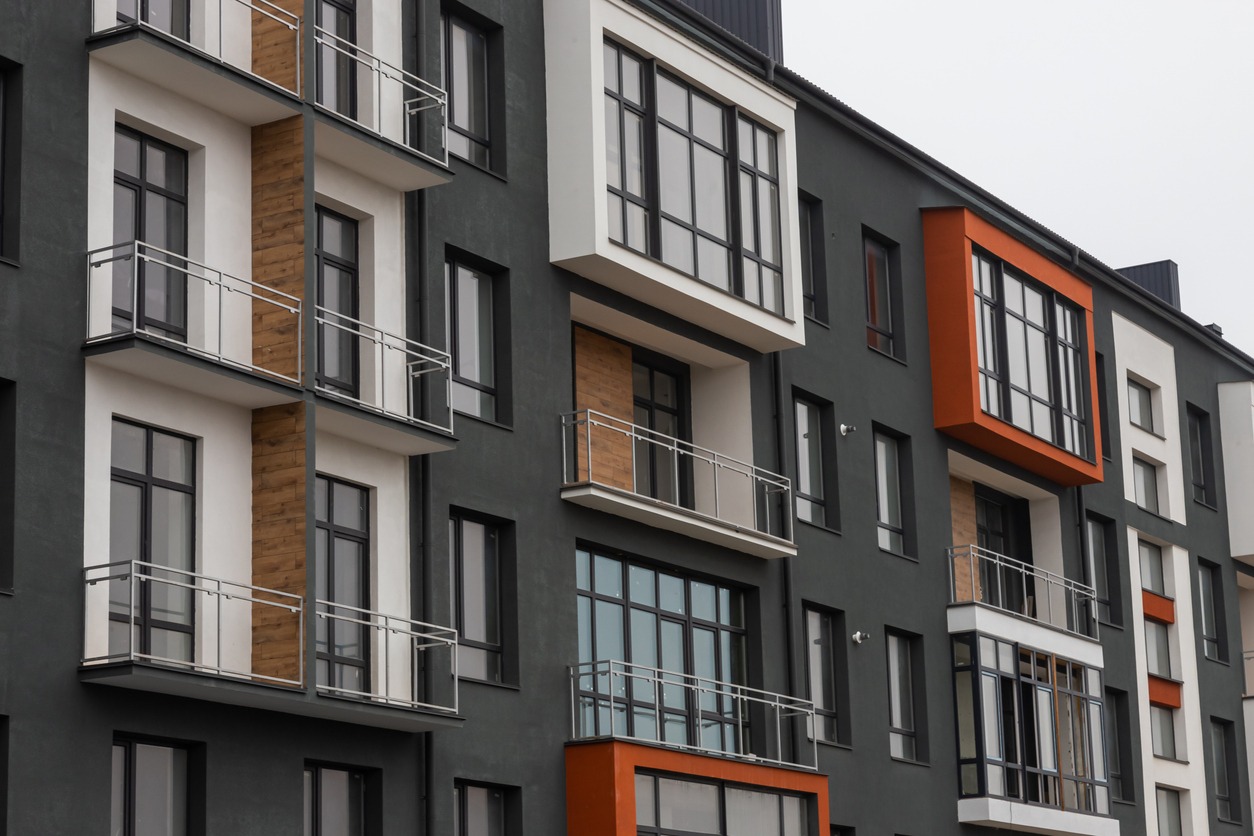 Fragment of Modern residential apartment with flat buildings exterior. Detail of New luxury house and home complex. Part of City Real estate property and condo architecture. Copy space