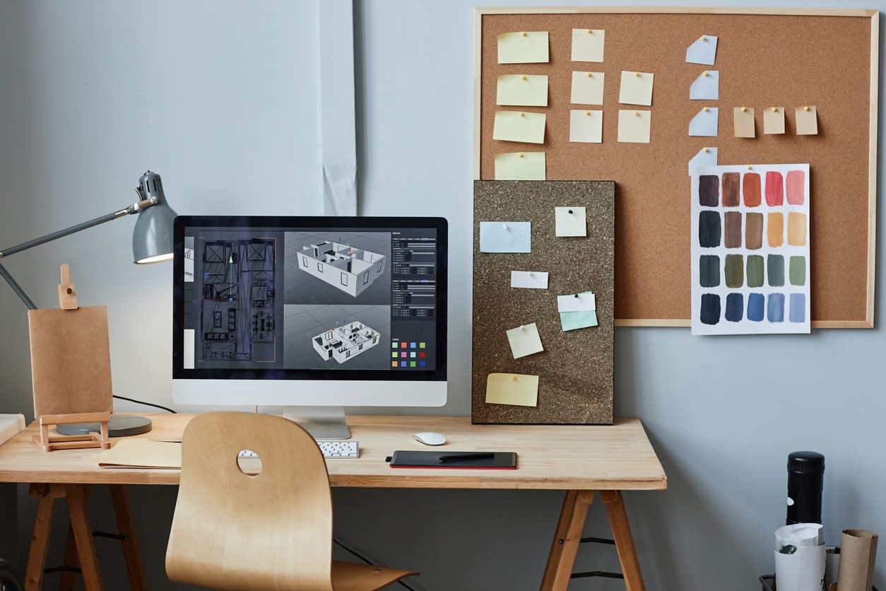 Computer with 3D house model on screen at workplace