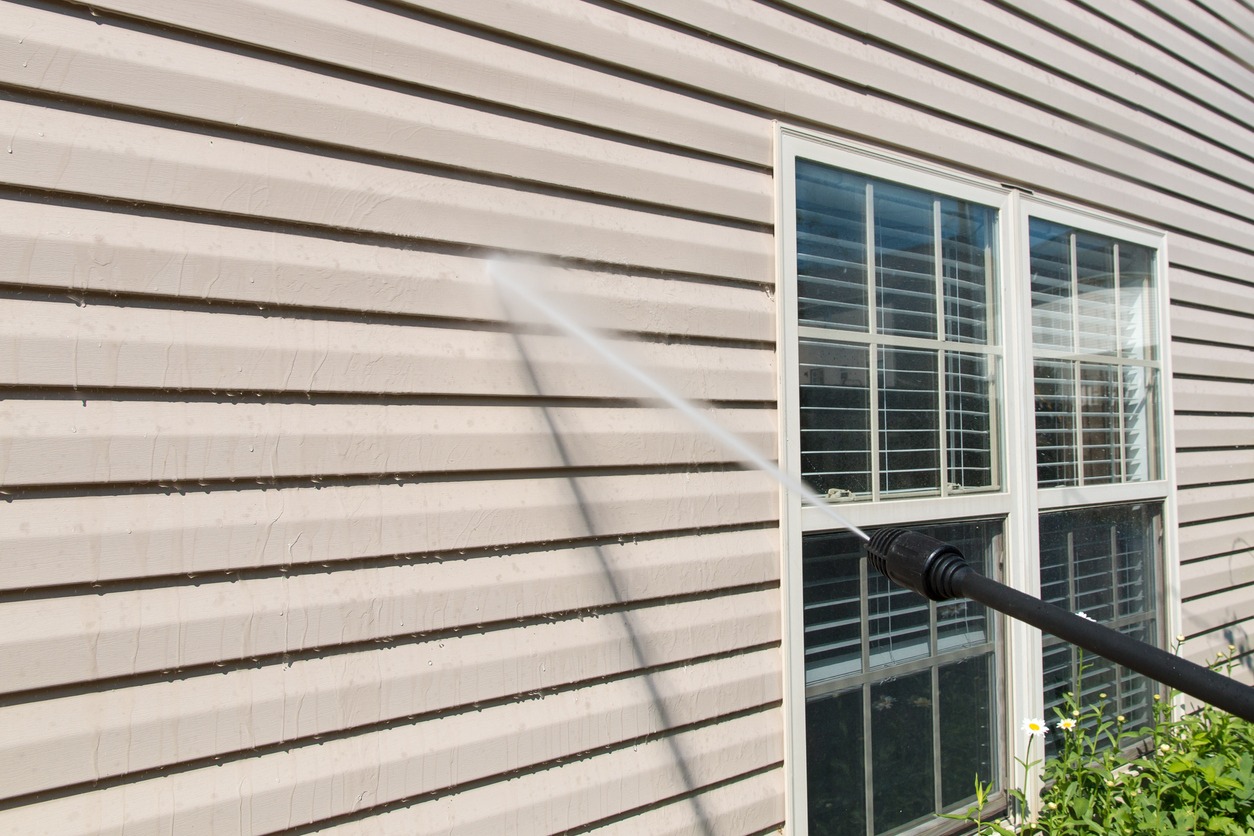 House wall vinyl siding cleaning with high pressure water jet