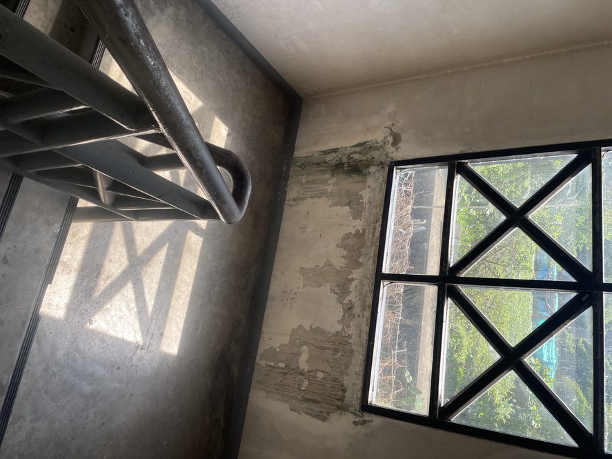 Light streams in through the window on the staircase.