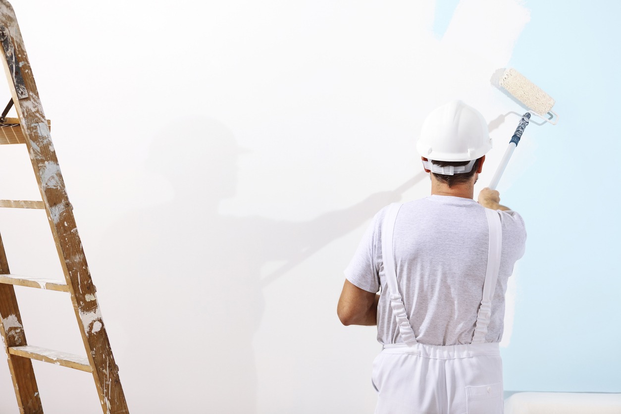 painter man at work with a paint roller